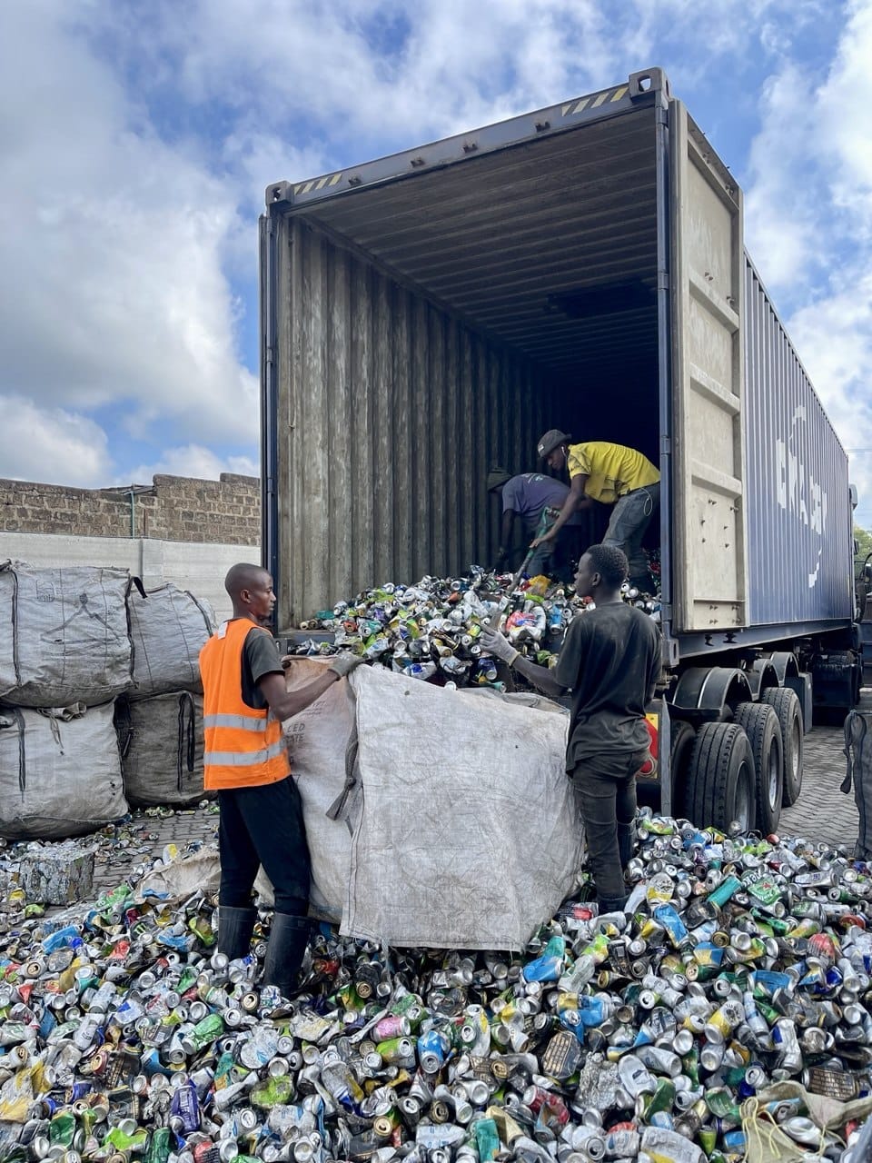 NUEF crew bagging baled aluminium cans beside an export container at the Nairobi yard